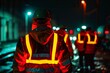 © Atonu - Construction workers standing together on a dimly lit street at night, engaged in conversation amidst their work environment. A night scene of construction workers wearing glow-in-the-dark
