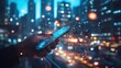 © Johannes - Hand using mobile smart phone, and wireless network connection technology in the city, with 5g internet networking sign