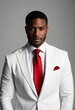 © Pixel Diversity - Professional portrait, well-groomed man, white suit, red tie, red pocket square, confident expression, dark skin, studio lighting, gray background, fashion photography, sharp focus, high contrast, ele