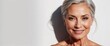 © VistaVisions - Beautiful gorgeous mid aged mature woman looking at camera isolated on white. Mature old lady close up portrait. Healthy face skin care beauty, middle age skincare cosmetics, cosmetology concept