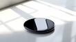 © Nopadol - A premium wireless charging pad with a smooth glossy finish, resting on a clean white surface