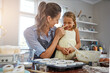© peopleimages.com - Bake, funny or playing with mom, girl or humor for bonding or learning dessert recipe in home. Flour, nose or mother teaching happy kid cooking skills for child development, cupcakes or silly joke