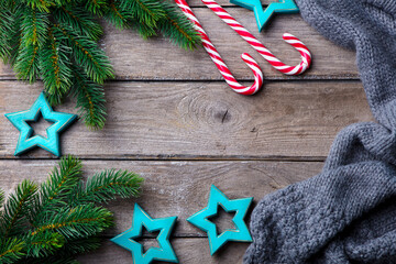 Wall Mural - Christmas and New Year decoration, fir tree and candy canes. Wooden background. Copy space. Top view.