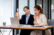 © David - Two asian business women Accounting using calculating income-expenditure and analyzing real estate investment documents data report Financial and tax systems concept.