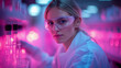 © sommersby - A woman in a lab coat and protective eyewear focuses on her work among glowing glass containers in a colorful laboratory environment