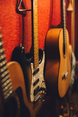 Electric, acoustic, and bass guitars in a music studio.