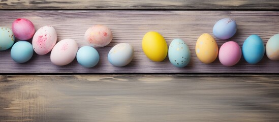 Fototapete - Pastel Easter eggs arranged on a rustic wooden board creating a festive and vibrant spring background with ample space for text or design.