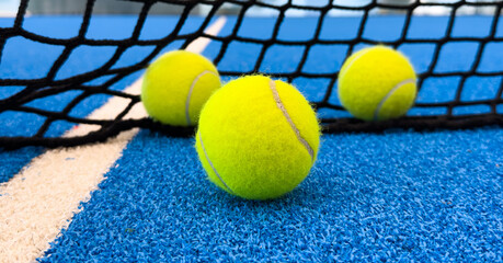 Wall Mural -  paddle tennis balls near the lines of a blue paddle tennis court, racket sports concept