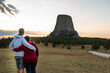 © kmlPhoto - An active retired couple stand with backs to the camera looking at Devils Tower in Wyoming. Looking to the future concept for older couple. with some clouds in the sky