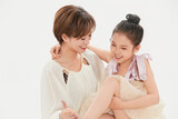 Beautiful mother and cute daughter portrait on white background