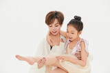 Beautiful mother and cute daughter portrait on white background