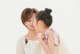 Beautiful mother and cute daughter portrait on white background