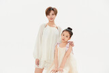 Beautiful mother and cute daughter portrait on white background