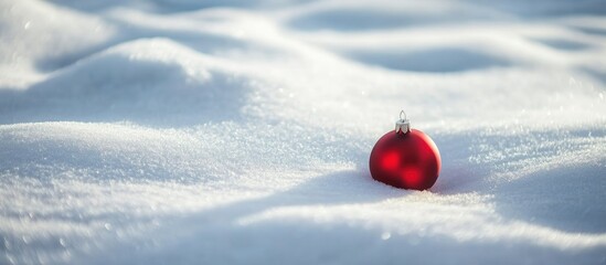 Sticker - Red Christmas ornament on pristine snow in winter holiday setting capturing festive spirit and seasonal beauty