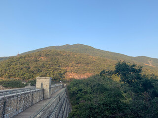 blue sky and mountain as nature in front of human made bridge with no one around