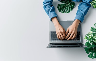 Canvas Print - Person in Blue Attire Typing on Laptop at White Table Top View Closeup Hands Working Online Office Desk Computer Keyboard Search Web Meeting Business Communication