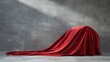 © Flowaiart - Elegant Red Fabric Covering an Unseen Object on a Simple Background