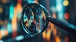 © stockagency - A magnifying glass focuses on a chart with colorful lines, representing data or trends, against a blurry background of city lights.