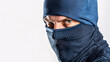 © mahamad - Burglar wearing a balaclava isolated on white.