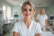 © liamalexcolman - Confident female healthcare professional smiling in a bright modern hospital room, symbolizing care and expertise.