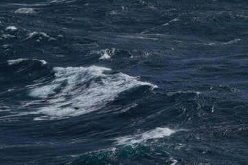 Wall Mural - waves crashing on dark ocean surface, creating dynamic and powerful scene. turbulent water showcases
