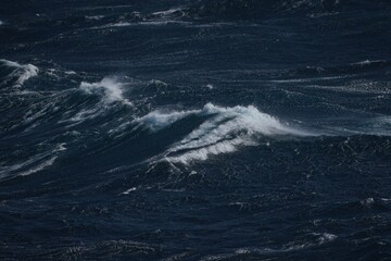 Wall Mural - dark ocean waves crashing in turbulent waters, creating dramatic scene