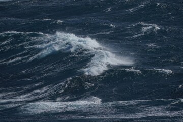 Wall Mural - powerful ocean waves crashing in stormy sea, creating dramatic scene of nature force