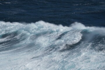 Wall Mural - majestic ocean waves crashing against each other, creating dynamic seascape. powerful movement and f
