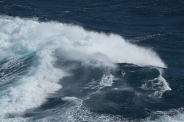 Wall Mural - powerful ocean waves crashing against shore create dramatic scene of nature force and beauty
