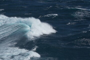 Wall Mural - powerful ocean waves crashing against shore create dramatic scene, showcasing beauty and force of na