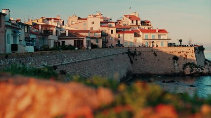 Wall Mural - View of different buildings on the coast in Antibes, France at sunset