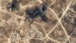 © Alexey - Aerial view of military attack aftermath with smoke rising from desert terrain. Satellite image showing damaged buildings and infrastructure. War zone landscape with visible destruction and copy space