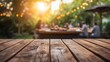 © Vladyslav Tykhonov - Empty wooden table and blurred view of a group of people having BBQ barbecue outdoors. Wood desk in front of a natural garden background