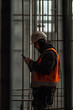 © Em Neems Photography - Worker with smartphone at construction site with space for text