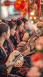 © SappiStudio - A group of musicians playing traditional Chinese instruments as part of a festive parade, with colorful decorations and flowers adorning the stage behind them. Vertical footage