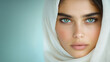 © Yulia - Serene gaze: young woman in white hijab with captivating blue eyes