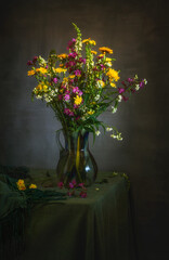 Wall Mural - Beautiful bouquet of meadow flowers in a glass jug close-up. Retro.