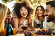 © mobile - Diverse friends enjoying picnic with wine and cheese in sunny park