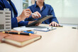 © R Photography - Asian business professionals and lawyer meet at desk, discussing city planning and high-rise building tax collection. They review contract papers, sign agreements, assess property tax and valuation.