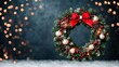 © Morninghead - A festive Christmas wreath adorned with red bow, ornaments, and warm lights, set against a blurred bokeh background.