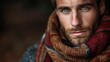 © Fana Art - Close-up portrait of a handsome man with blue eyes wearing a warm scarf.