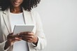 © Alexandr - Black woman in white suit using tablet, half-face visible