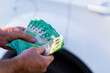 © Austockphoto - Middle aged mans hand holding one hundred dollar notes in Australian cash to pay for car