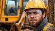 © anantachat - Worker wearing safety goggles operating heavy machinery with clear visual warnings and instructions displayed nearby Stock Photo with side copy space