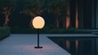 © Lifestyle Images - A lamp post with a lighted globe on top stands in front of a pool