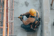 © Fabio - Close-up of a construction worker drilling into a concrete wall