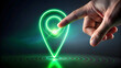© JidapaDesign - finger touching glowing green location pin, symbolizing navigation and technology. image conveys sense of connection and modernity