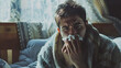 © mahamad - Sick young man suffering from flu at home.
