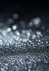 Wall Mural - shimmering silver sparkles on a dark background create a mesmerizing texture. soft blue lights creat