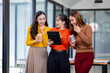 © David - Three happy young asian women corporate executives meeting in the office discussing business targets.